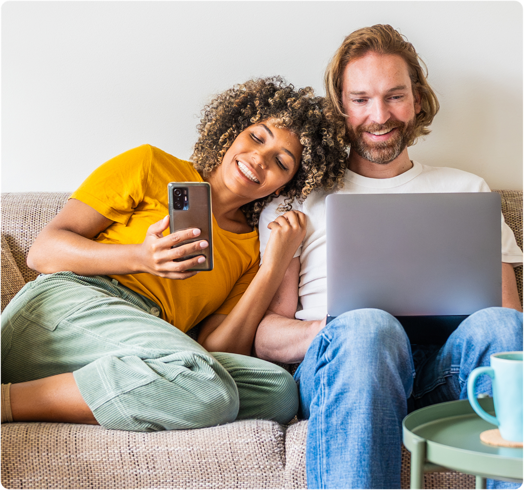 Woman leaning on man working on laptop